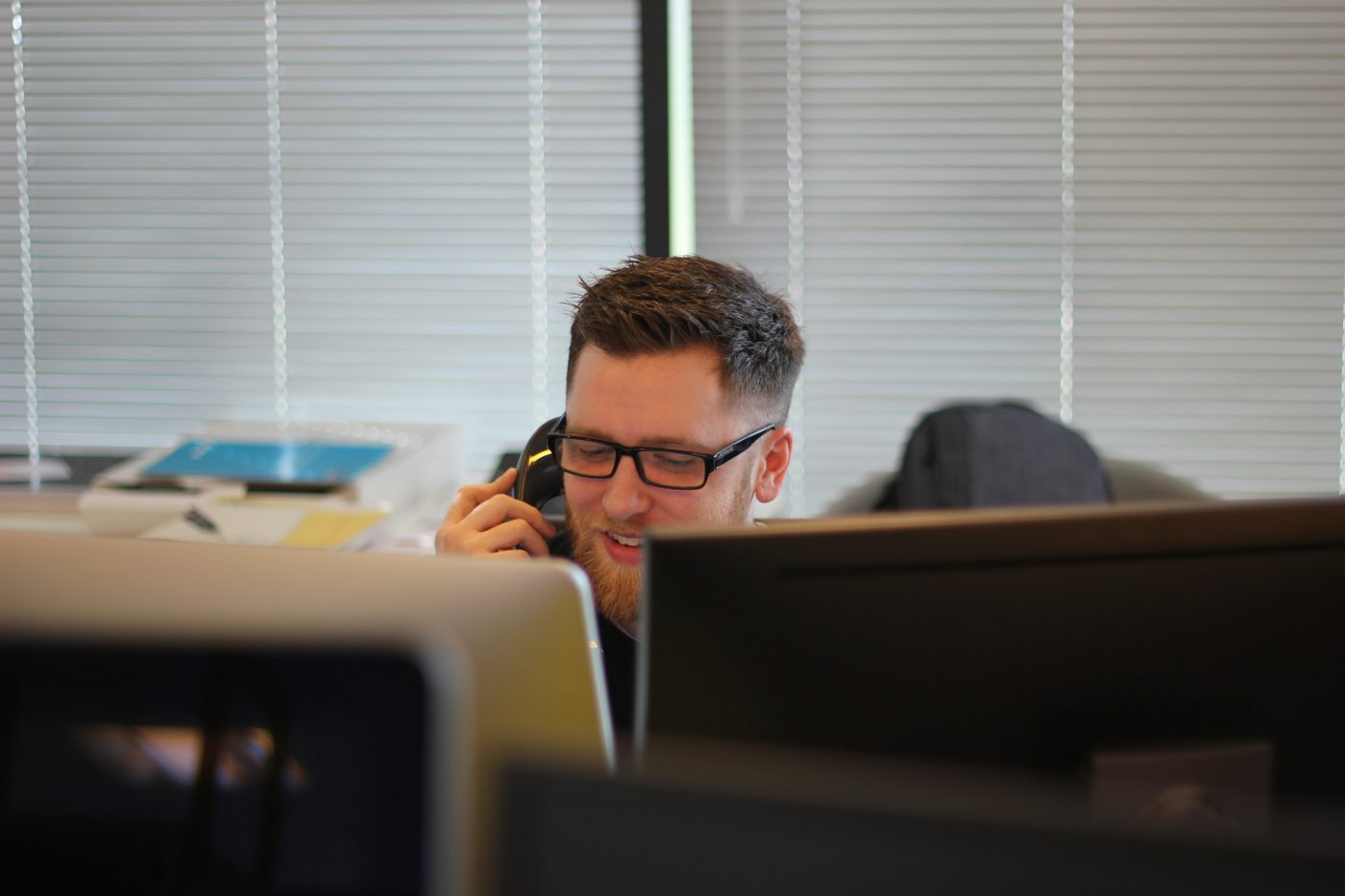 Owner on a video call at a home office desk