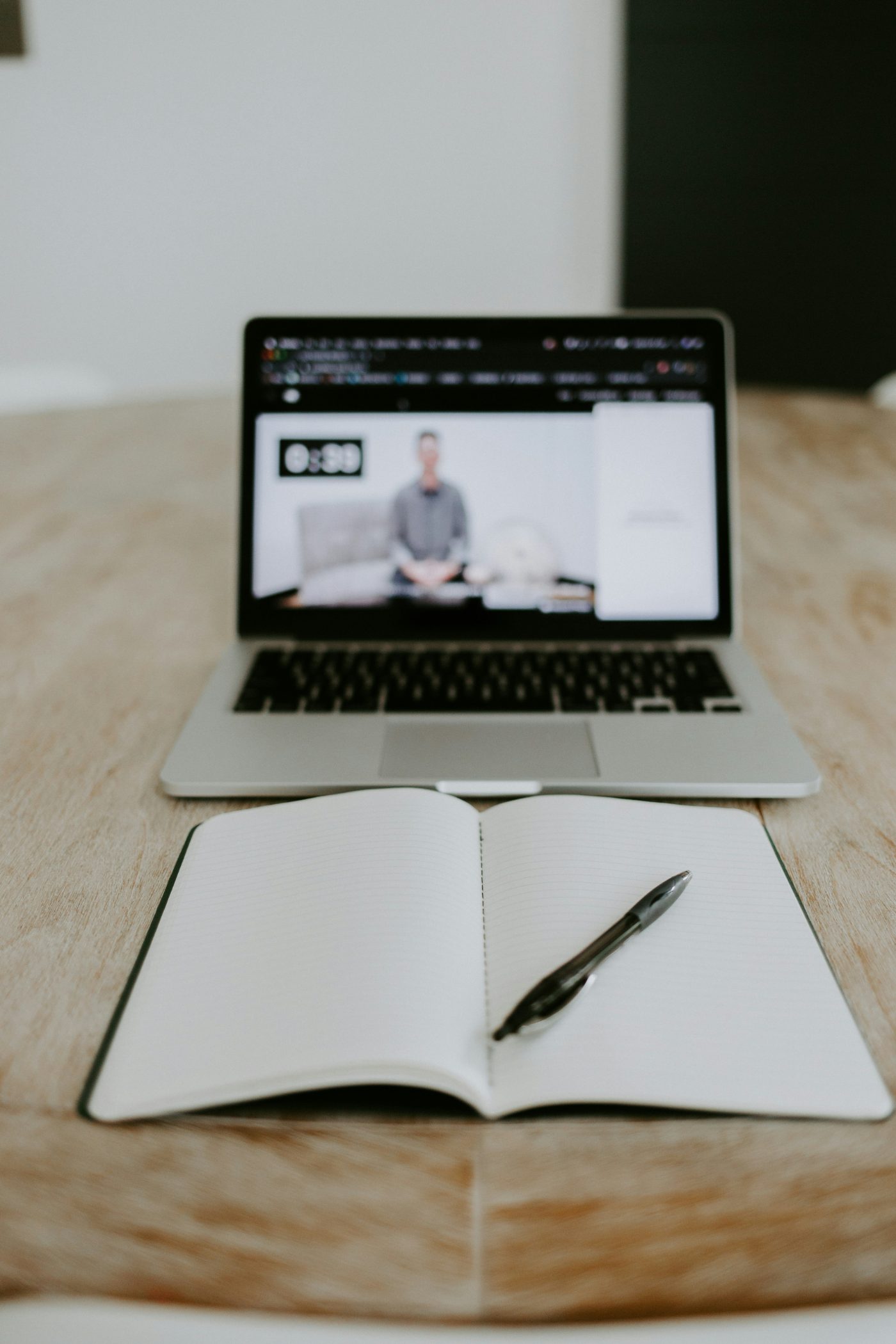 Training video open beside an empty notebook